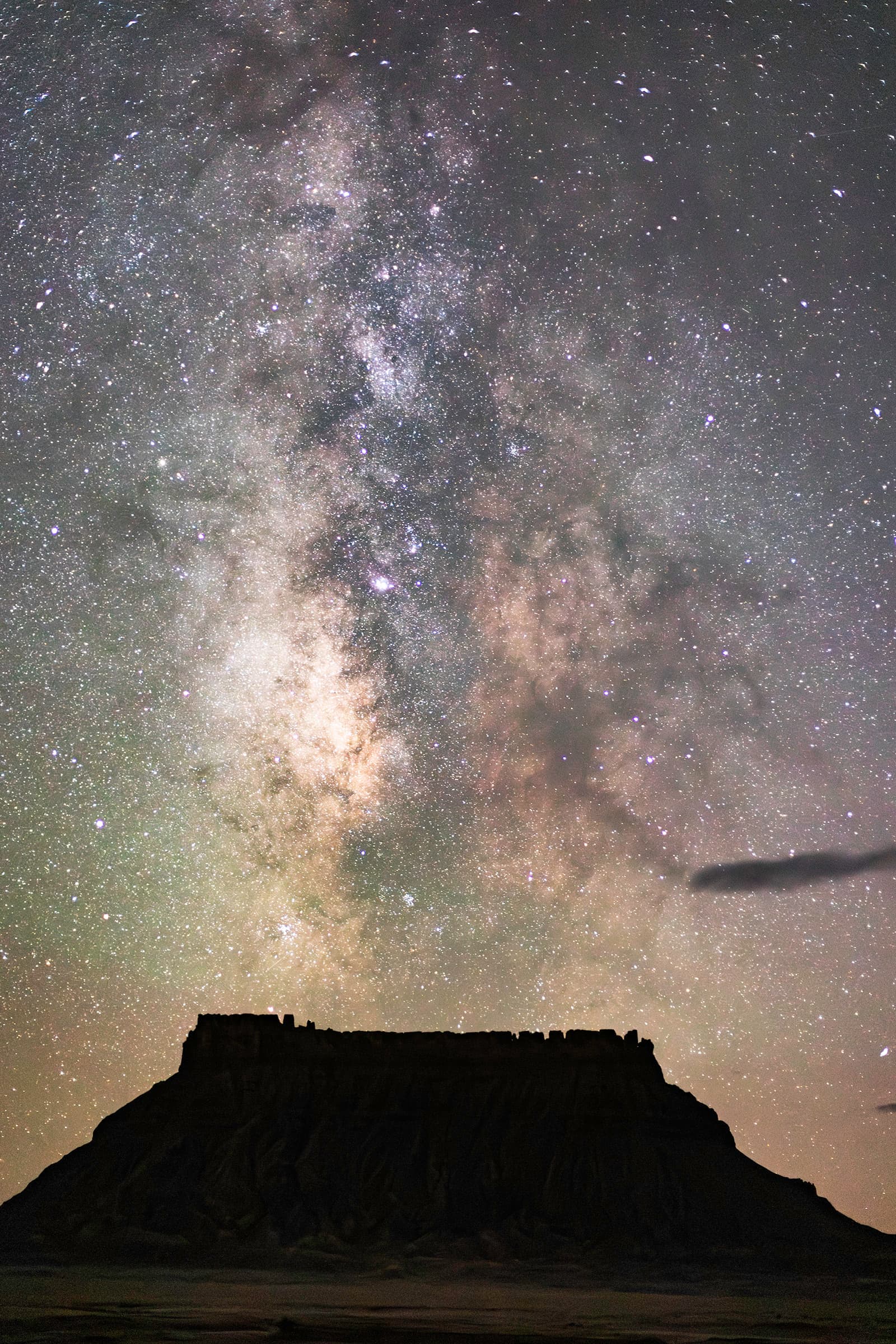 Factory Butte desert forms under a vertical night sky